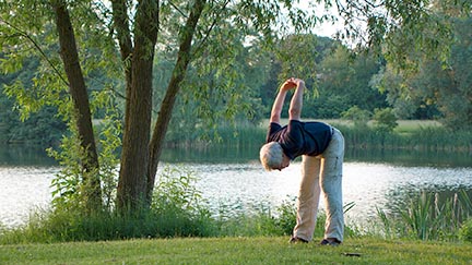 Man stretching his shoulders on golf course