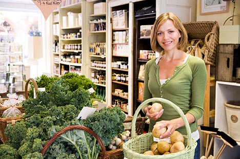 Woman shopping for produce in upscale market
