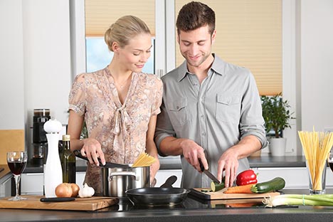 pic of man and woman cooking in kitchen