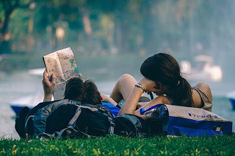 pic of couple reading map realxing in park