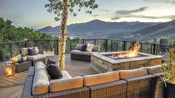 Beautiful back deck with fire pit and mountains in the distance