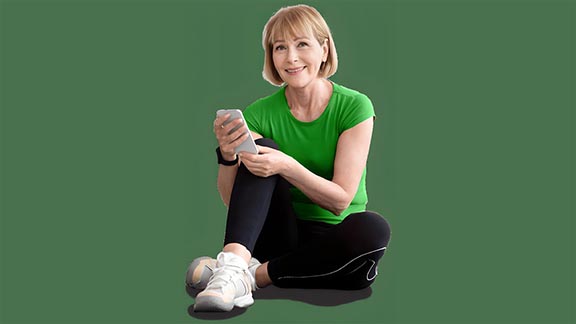 Woman sitting holding her phone