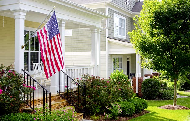 A beautiful home with an American Flag in front of it